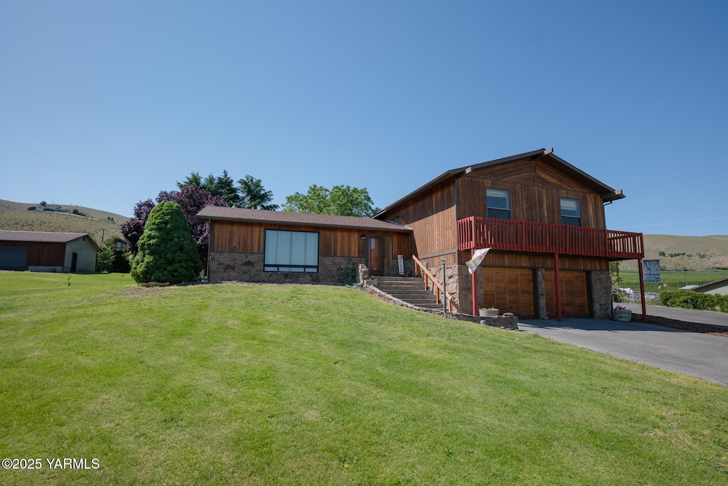 1014 Meadowbrook Rd, Yakima, WA 98903 - view of front of home with asphalt driveway, a front lawn, an attached garage, and stone siding
