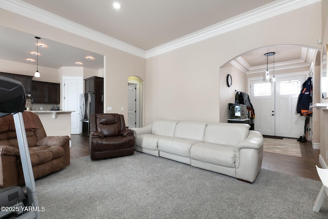 living room with ornamental molding, arched walkways, recessed lighting, and wood finished floors