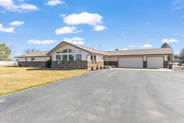 41 Alteejen Rd, Zillah, WA 98953 - view of front of property featuring a garage, stone siding, driveway, and a front yard