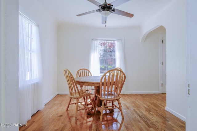 418 S 32nd Ave, Yakima, WA 98902 - dining room with arched walkways, light wood-style flooring, a ceiling fan, and baseboards