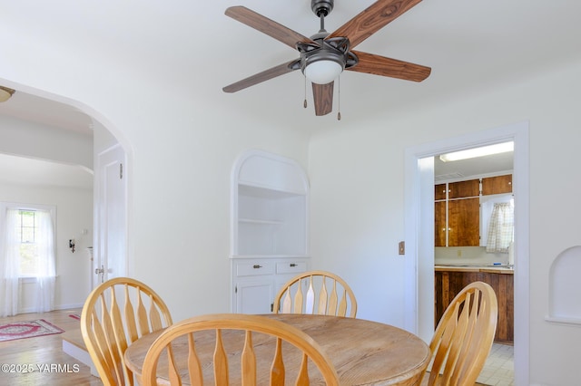 418 S 32nd Ave, Yakima, WA 98902 - dining space featuring a ceiling fan, arched walkways, light wood-style flooring, and baseboards