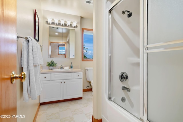 1011 N 79th Ave, Yakima, WA 98908 - full bathroom featuring baseboards, vanity, marble look tiles, toilet, and enclosed tub / shower combo