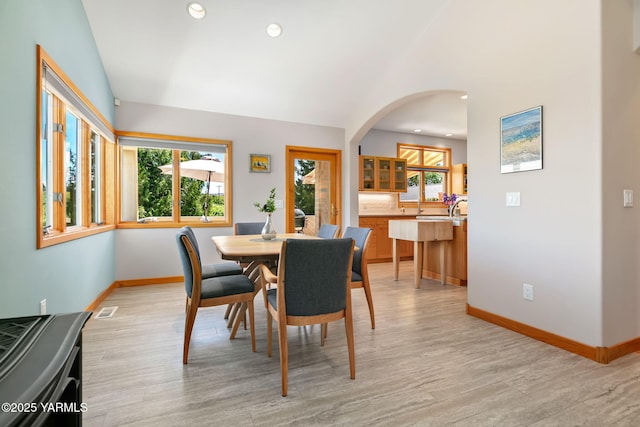 1011 N 79th Ave, Yakima, WA 98908 - dining room with baseboards, arched walkways, light wood-style flooring, recessed lighting, and vaulted ceiling