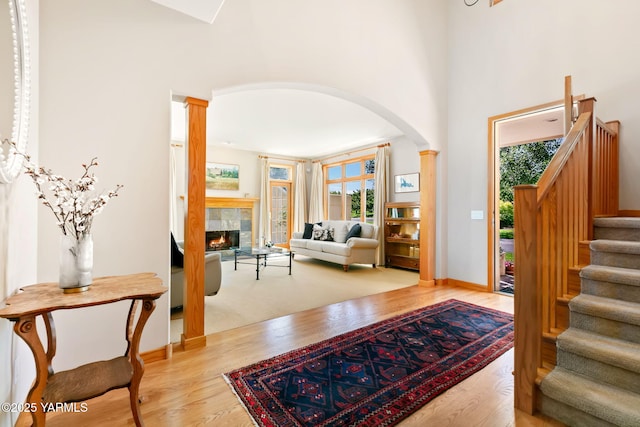 1011 N 79th Ave, Yakima, WA 98908 - foyer entrance with arched walkways, wood finished floors, a fireplace, stairs, and baseboards