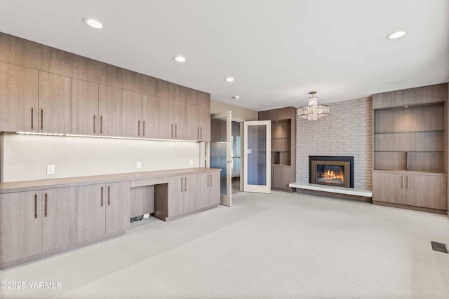 5902 Glacier Way, Yakima, WA 98908 - kitchen with a desk, a brick fireplace, recessed lighting, light brown cabinetry, and light carpet