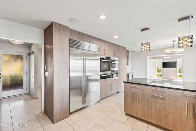 5902 Glacier Way, Yakima, WA 98908 - kitchen featuring appliances with stainless steel finishes, a warming drawer, light tile patterned floors, decorative light fixtures, and recessed lighting