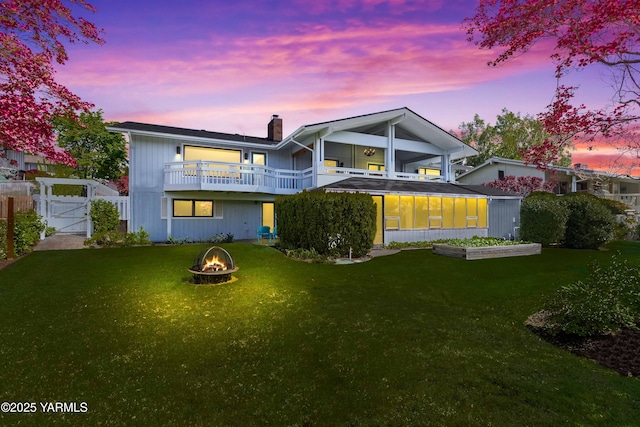 5902 Glacier Way, Yakima, WA 98908 - back of property featuring a gate, a fire pit, a chimney, and a balcony