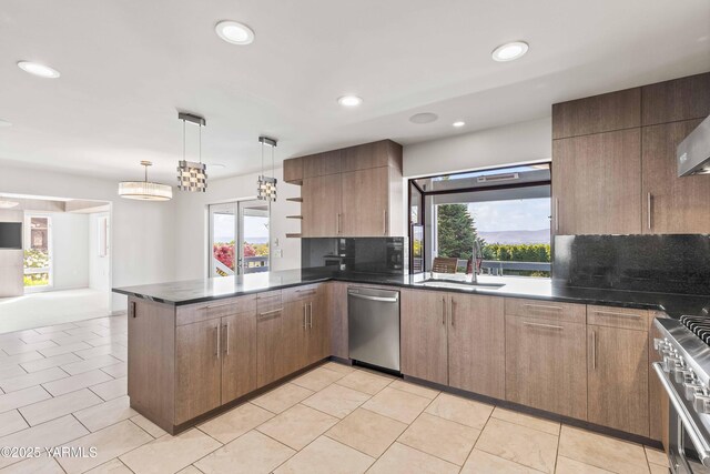 5902 Glacier Way, Yakima, WA 98908 - kitchen featuring a sink, appliances with stainless steel finishes, a peninsula, dark countertops, and plenty of natural light
