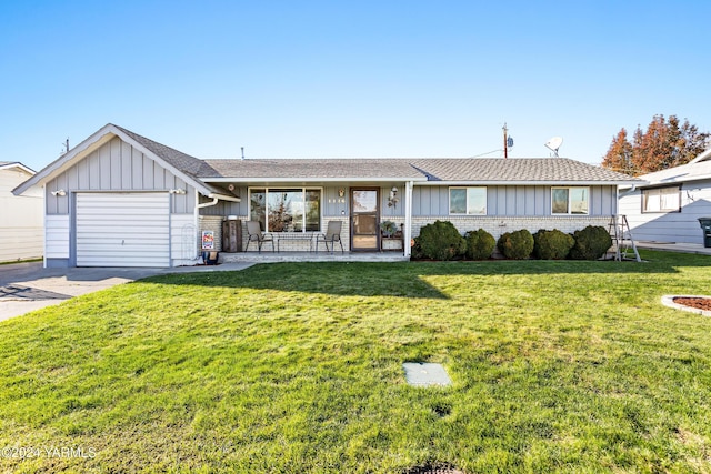 ranch-style home with brick siding, an attached garage, board and batten siding, driveway, and a front lawn