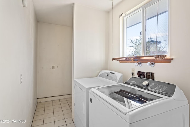 laundry area featuring laundry area, washer and clothes dryer, and light tile patterned floors