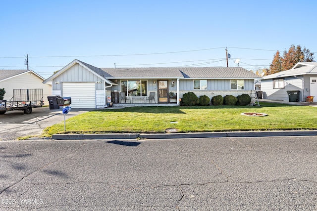 single story home with a shingled roof, an attached garage, board and batten siding, a front yard, and driveway