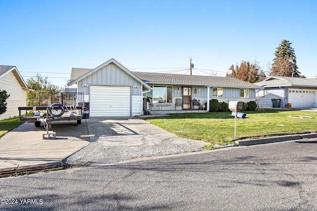 single story home featuring covered porch, board and batten siding, a garage, driveway, and a front lawn