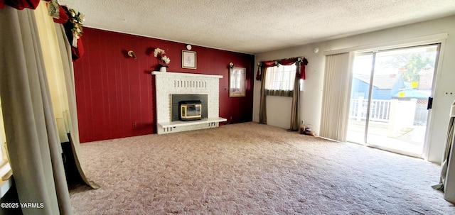 unfurnished living room featuring a brick fireplace, a textured ceiling, and carpet floors