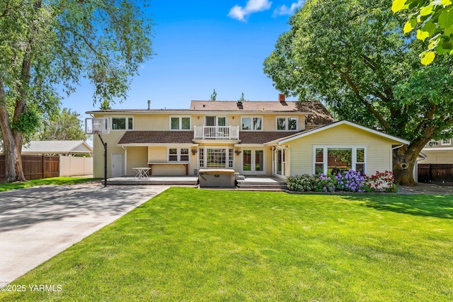 3703 W Chestnut Ave, Yakima, WA 98902 - view of front of home featuring a balcony, concrete driveway, a chimney, a hot tub, and french doors