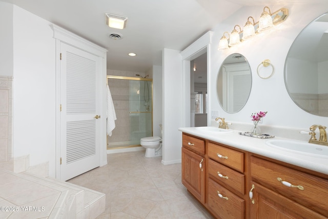 3703 W Chestnut Ave, Yakima, WA 98902 - full bath with double vanity, a shower stall, tile patterned flooring, toilet, and recessed lighting