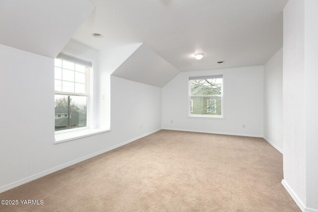 unfurnished living room with light colored carpet, recessed lighting, and baseboards