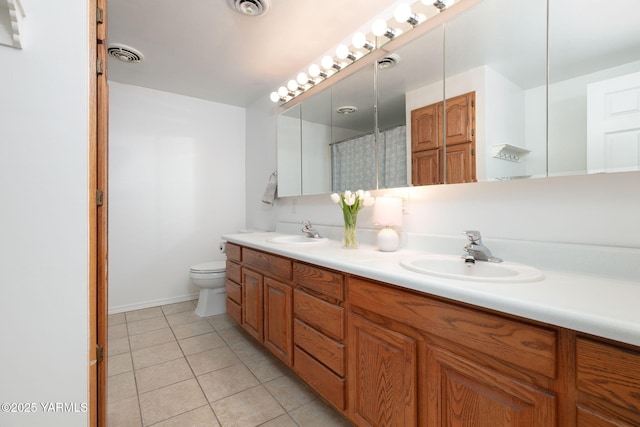 3703 W Chestnut Ave, Yakima, WA 98902 - full bathroom featuring double vanity, tile patterned floors, and toilet