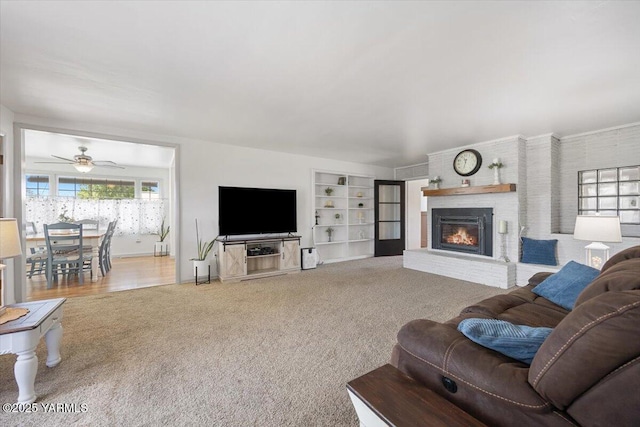 3700 Sheller Rd, Sunnyside, WA 98944 - living room with carpet floors, a fireplace, built in features, and a ceiling fan