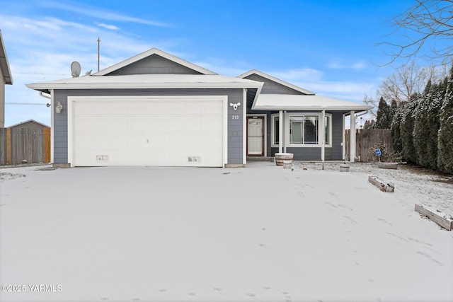 ranch-style home with an attached garage, fence, and driveway