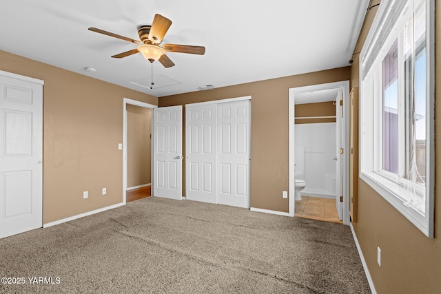 unfurnished bedroom featuring carpet flooring, connected bathroom, visible vents, and baseboards