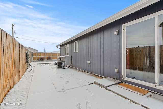 view of side of home with central air condition unit, a patio, and a fenced backyard