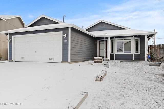 ranch-style home with an attached garage and fence