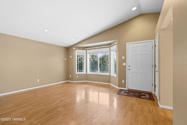 foyer with recessed lighting, baseboards, light wood-style flooring, and vaulted ceiling