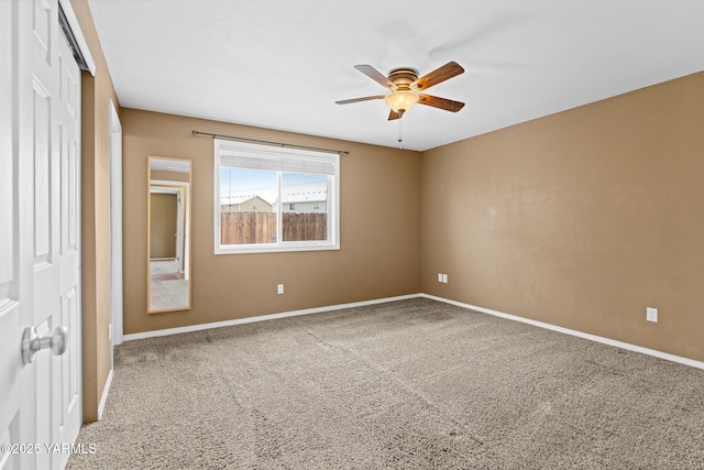 unfurnished bedroom featuring a closet, baseboards, carpet, and ceiling fan