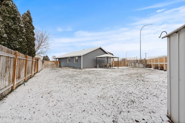 rear view of property with a gazebo, a patio, and a fenced backyard