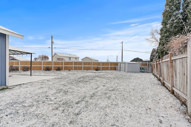 view of yard featuring a storage shed, an outbuilding, and a fenced backyard