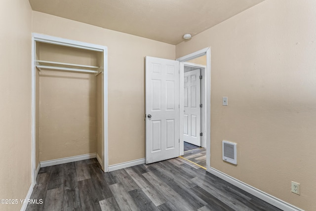 921 N 29th Ave, Yakima, WA 98902 - unfurnished bedroom with dark wood finished floors, a closet, and heating unit