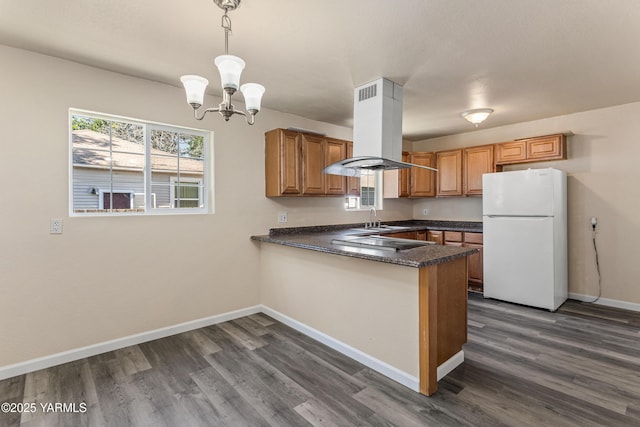 921 N 29th Ave, Yakima, WA 98902 - kitchen featuring freestanding refrigerator, island exhaust hood, dark wood finished floors, and a peninsula