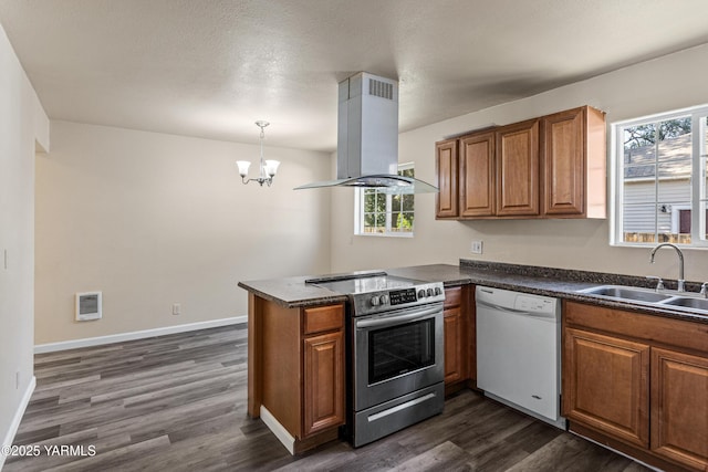 921 N 29th Ave, Yakima, WA 98902 - kitchen featuring white dishwasher, island exhaust hood, stainless steel electric range, brown cabinets, and dark countertops