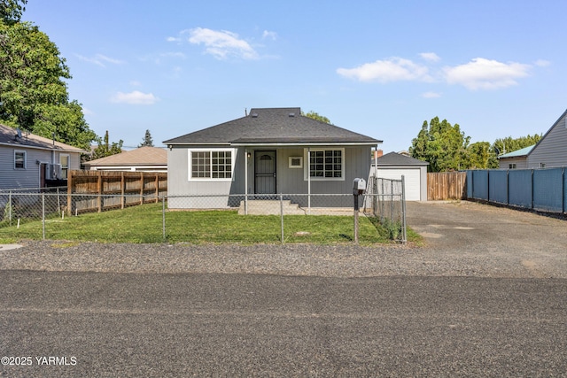 921 N 29th Ave, Yakima, WA 98902 - bungalow-style house featuring a fenced front yard, an outbuilding, a garage, and driveway