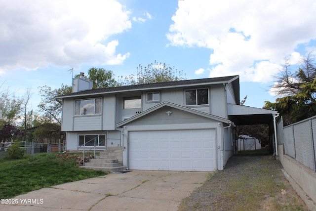 215 S Ridgeway Dr, Yakima, WA 98901 - view of front of house featuring a chimney, driveway, an attached garage, and fence