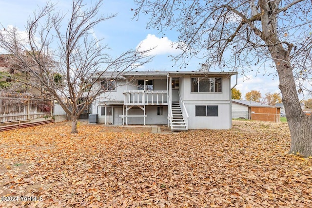 rear view of property with central AC, fence, stairway, and a balcony