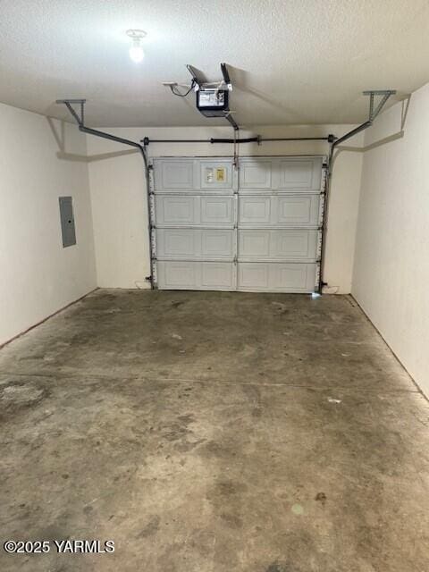 garage with electric panel and a garage door opener