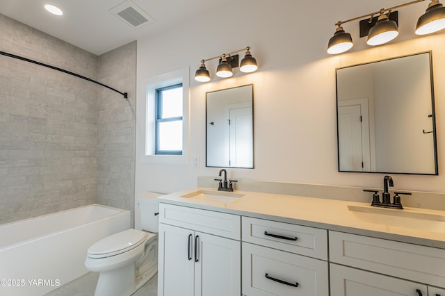 full bath with shower / bath combination, visible vents, a sink, and double vanity