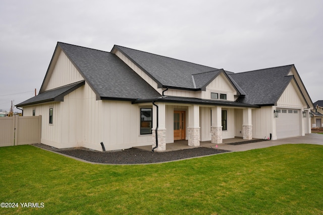 modern inspired farmhouse with a porch, roof with shingles, an attached garage, a front lawn, and board and batten siding