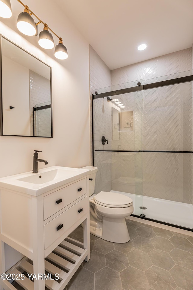 full bath featuring vanity, a shower stall, and toilet