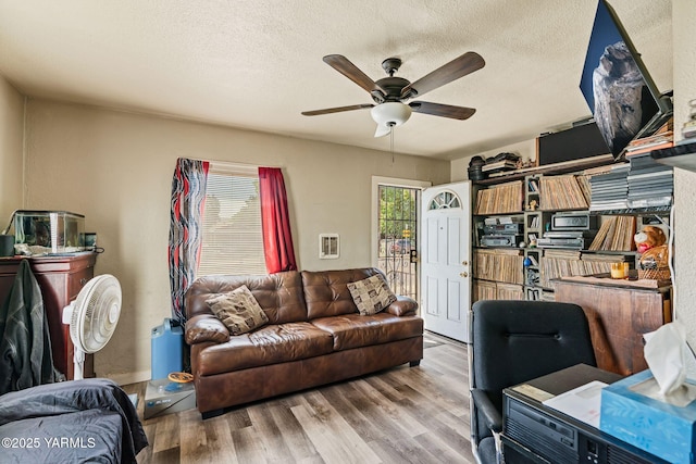 1311 W Mead Ave, Yakima, WA 98902 - living room with ceiling fan, wood finished floors, and a textured ceiling