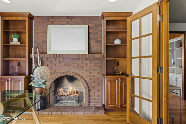 unfurnished living room featuring a fireplace, wood finished floors, and recessed lighting