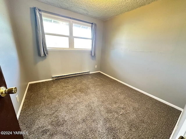 empty room featuring carpet floors, baseboards, a textured ceiling, and baseboard heating