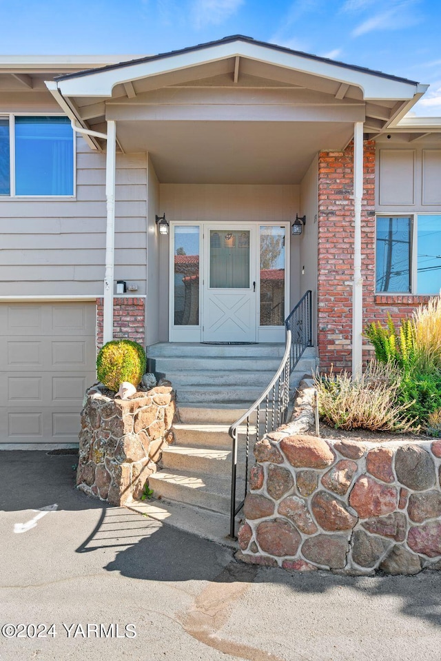 view of exterior entry with brick siding