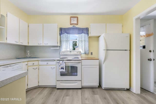 kitchen featuring light countertops, light wood-style floors, white cabinets, and white appliances