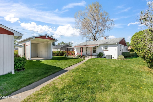 back of house featuring a porch, a chimney, a yard, and central AC