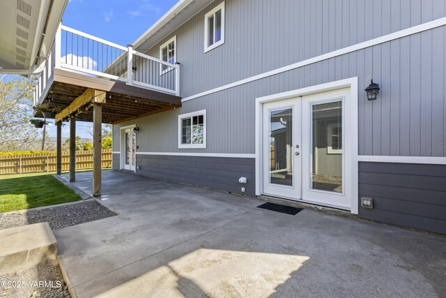 view of patio featuring fence and french doors