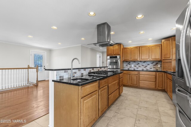 kitchen featuring stainless steel appliances, a sink, island exhaust hood, crown molding, and a center island with sink