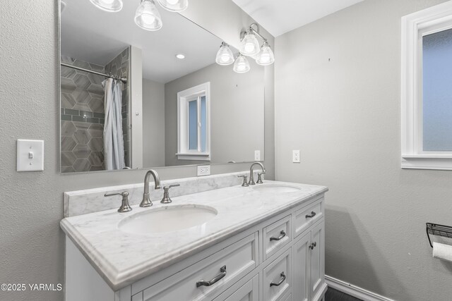 full bathroom with double vanity and a shower with shower curtain