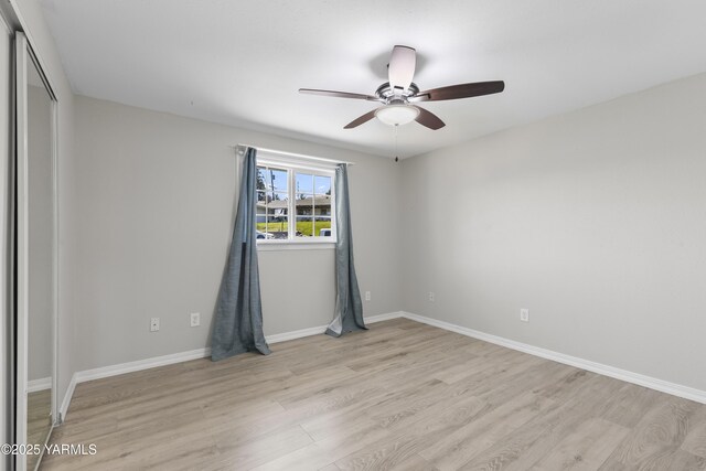 unfurnished room with light wood-style floors, a ceiling fan, and baseboards